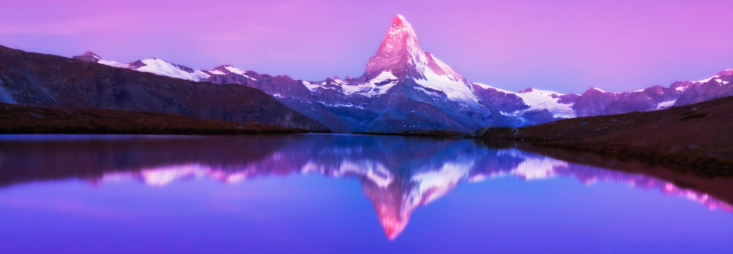 Beautiful sunset colors and cloudscape in the Swiss Alps in summer, with Matterhorn reflection in a glacier lake